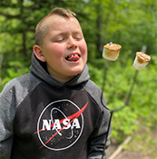 boy getting ready to eat two roasted marshmallows