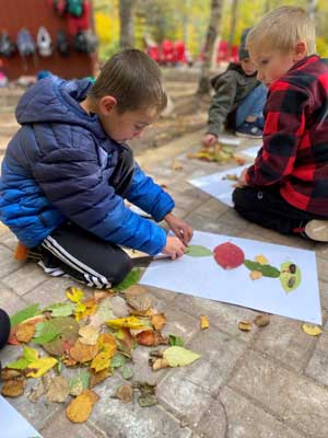 Boys making leaf art