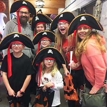 Group of happy adults and students dressed up as pirates