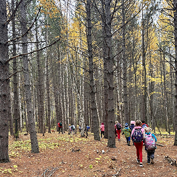 Student going on a hike in the woods