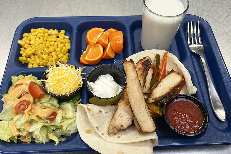 Chicken Fajitas, corn, green salad, fruit, milk/water