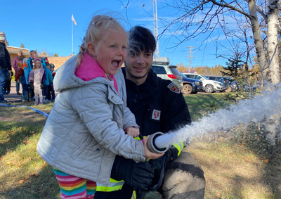 Little girl with a hose