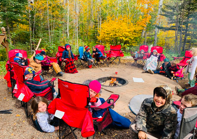 Students sitting around a firepit outside