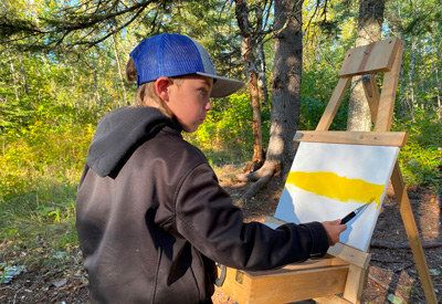 student painting outside