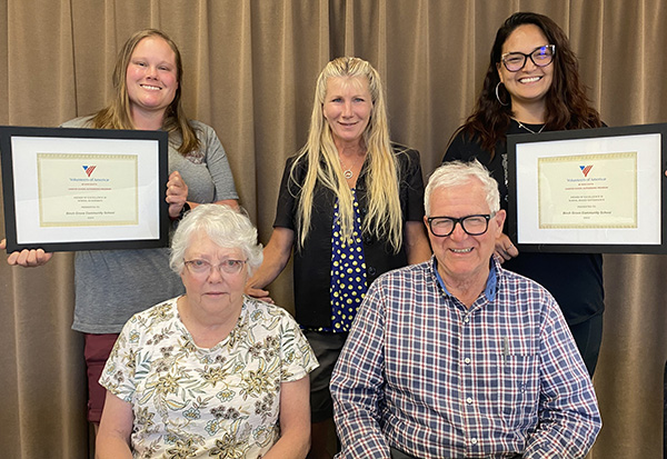 School board members posing with a certificate