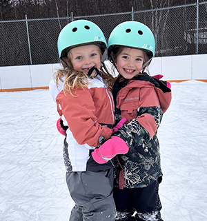 Boy ice skating and wearing a helmet for hockey