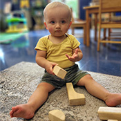 student playing with wooden blocks